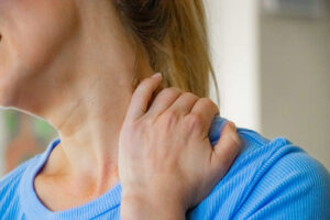 Neck pain woman holding neck
